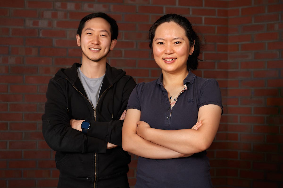 Kikoff co-founders Christophe Chong, left, and Cynthia Chen standing against a brick wall