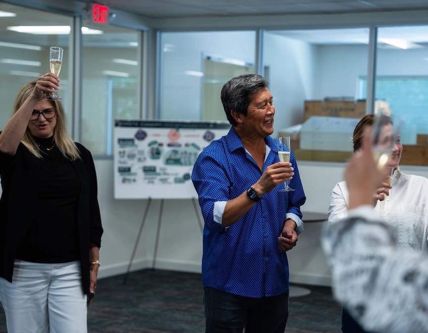 Cynthia Perazzo, left, and Yulun Wang, center, join colleagues in a toast