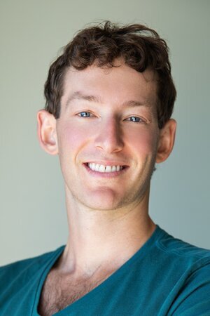 Dakin Sloss in a teal shirt, in an archival SALT speaker photograph