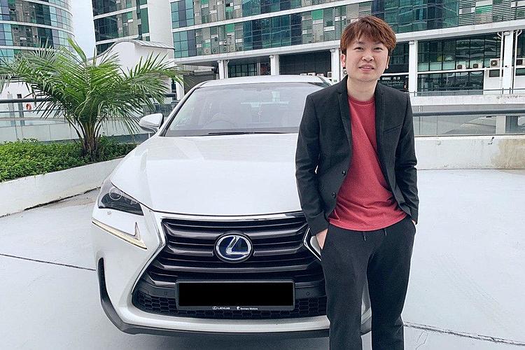 Damian Sia standing beside a white Lexus in a car park