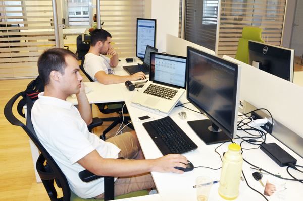 Members of HR Cloud's Split team working at computer workstations in 2013