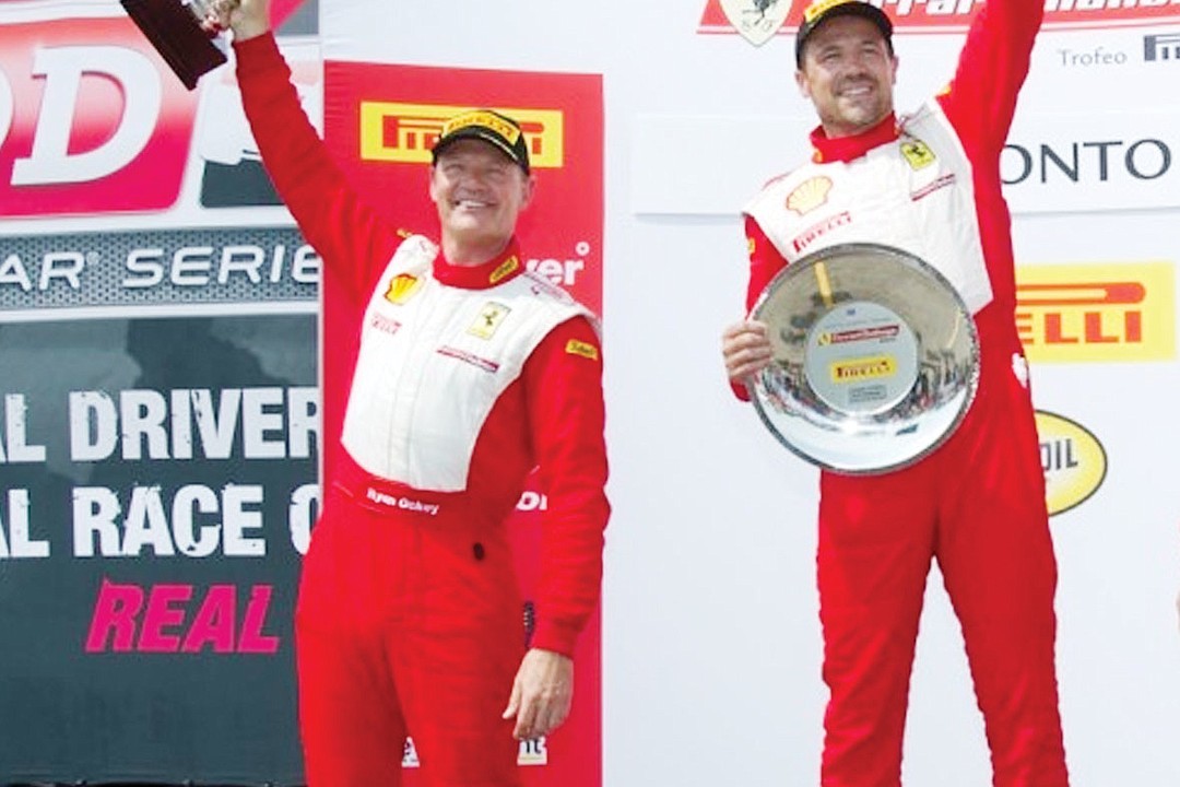 Ryan Ockey and Damon Ockey celebrating on a Ferrari Challenge podium