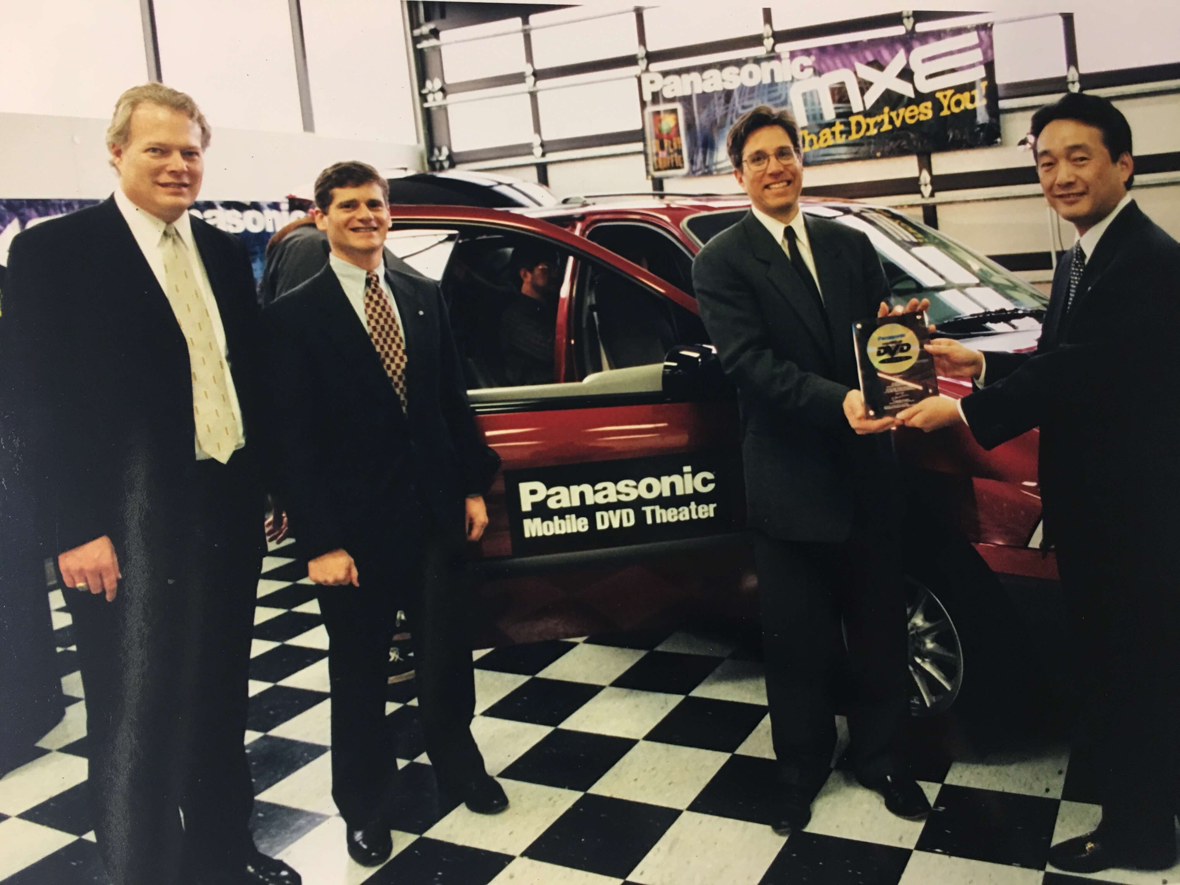 Dan Brettler, second from right, with colleagues and a Panasonic Mobile DVD Theater demonstration vehicle
