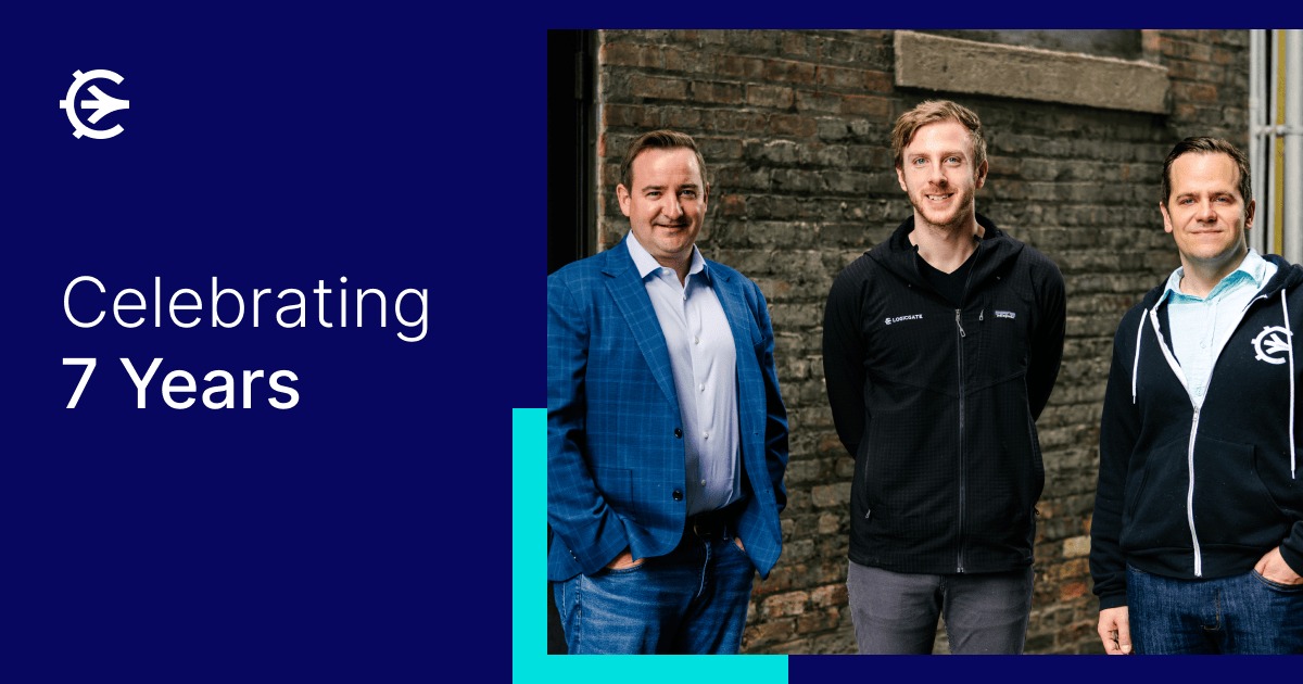 LogicGate co-founders Matt Kunkel, Dan Campbell and Jon Siegler standing together outside a brick building