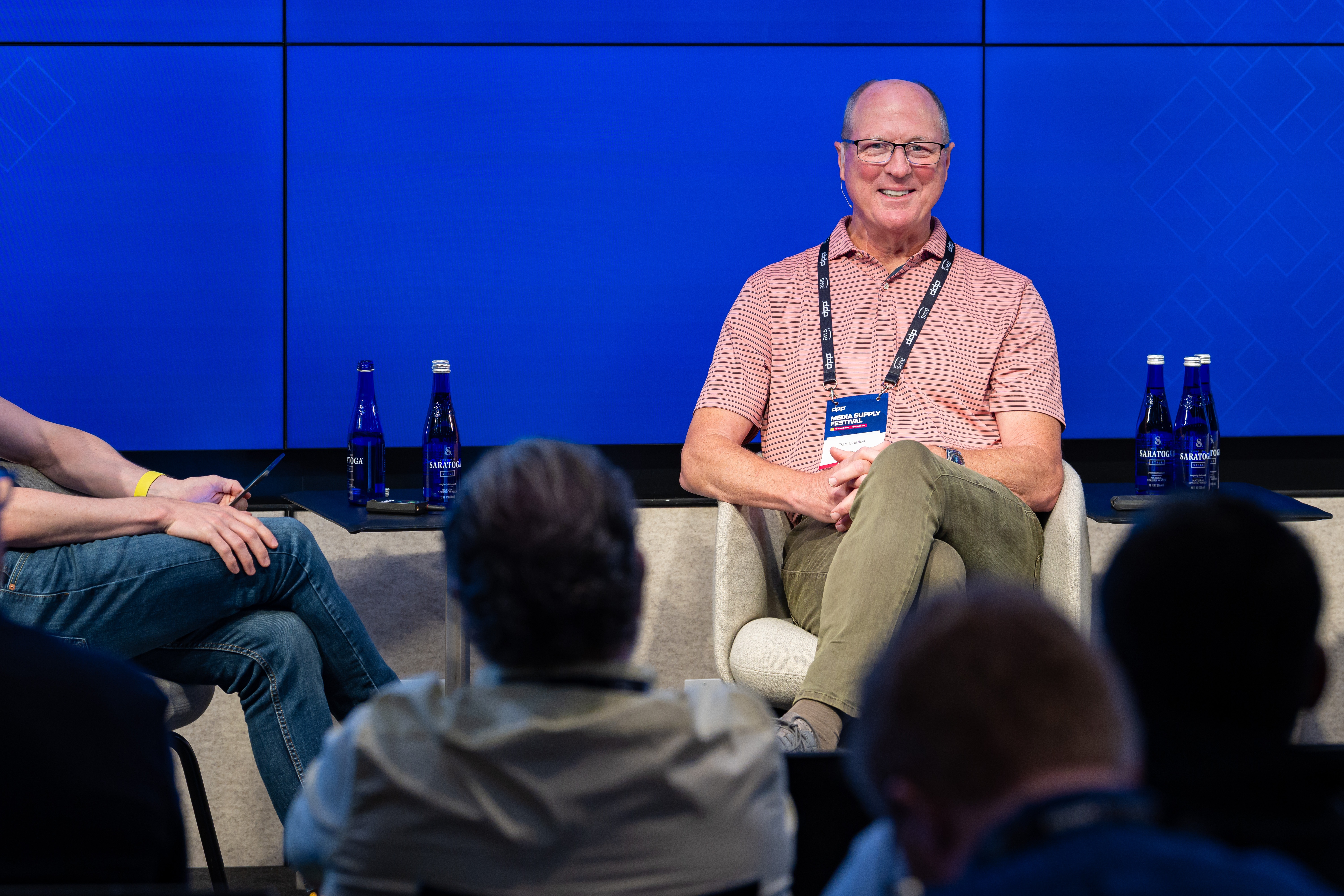 Dan Castles seated on stage, smiling during his executive interview at the DPP Media Supply Festival 2025