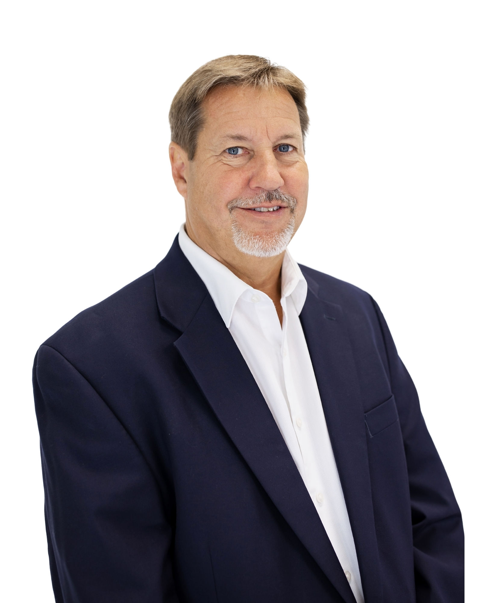 Dan Geelhoed in an earlier SpendMend company portrait, wearing a navy jacket and open-collar white shirt