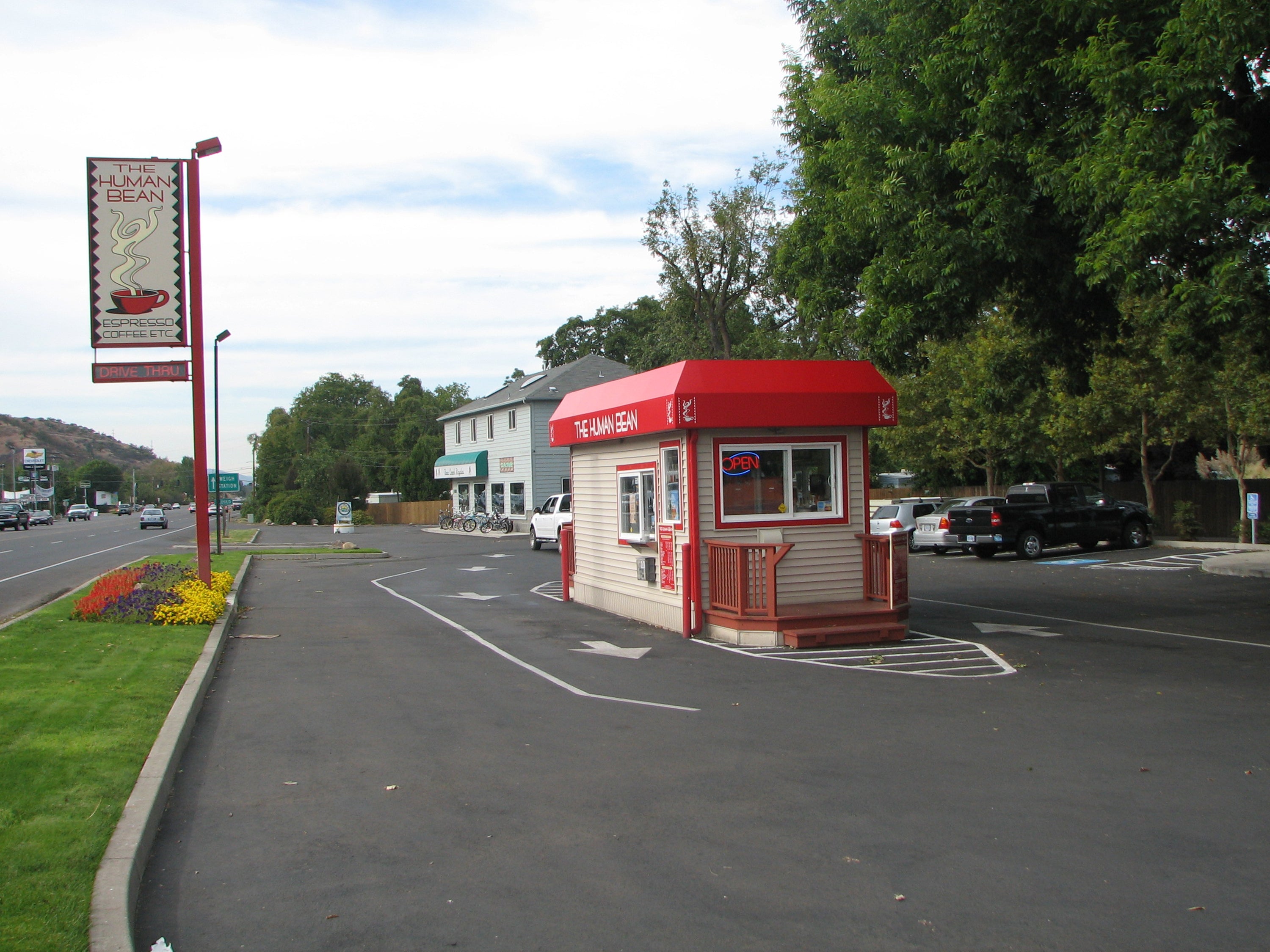 The original Human Bean coffee stand in Ashland, Oregon, with its red canopy and drive-thru lane