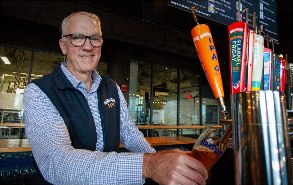 Dan Kenary pours a Harpoon IPA behind a brewery bar