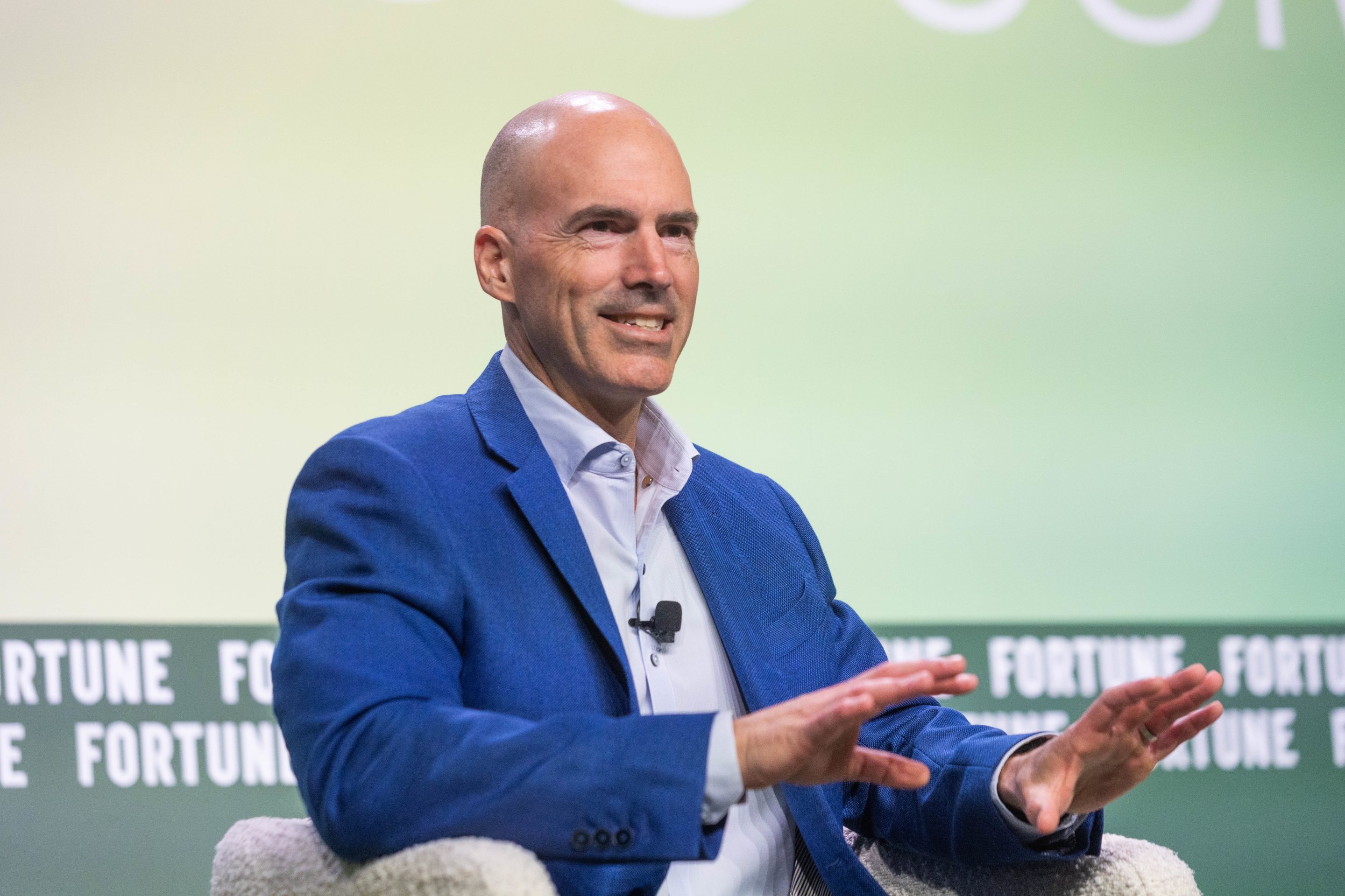 Dan Peyovich speaking and gesturing with both hands at Fortune’s COO Summit in June 2026