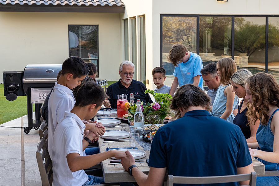 Dan Thiessen seated with family members around an outdoor dining table