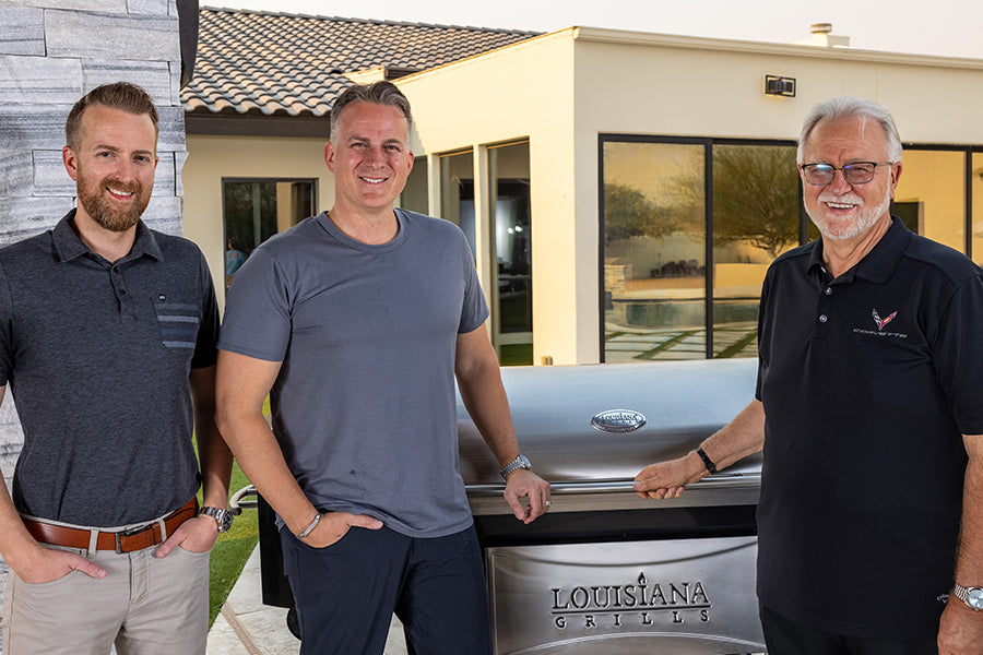 Jordan, Jeff and Dan Thiessen standing beside a Louisiana Grills cooker