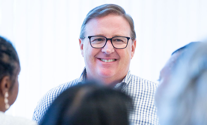 Dan Zortman smiling among a small group of Sysmex associates