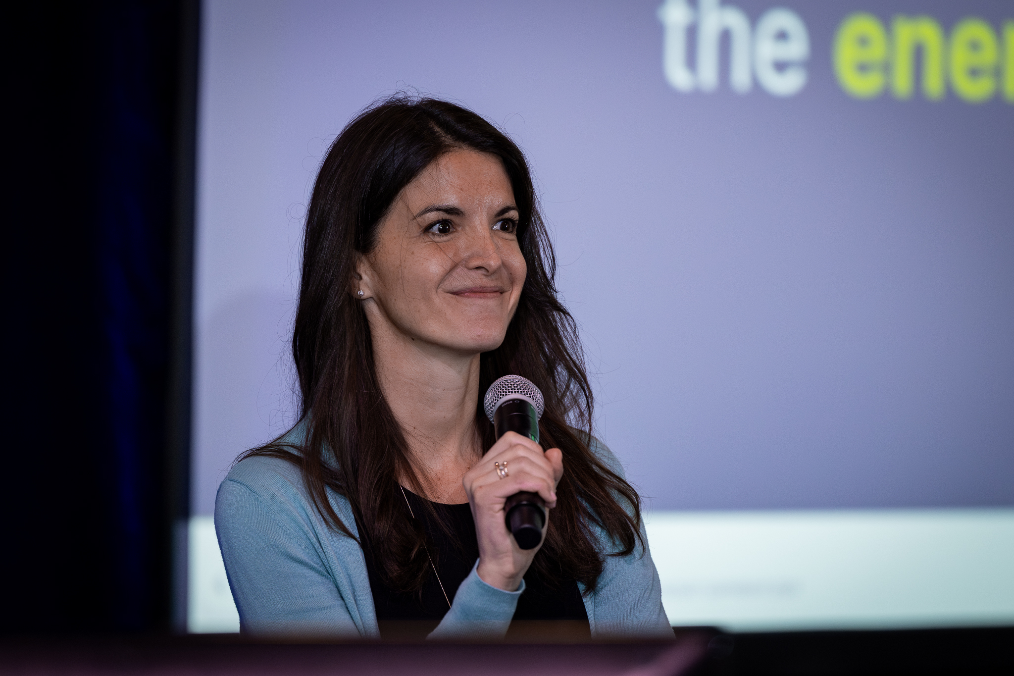 Dana Guernsey holding a microphone during a public discussion