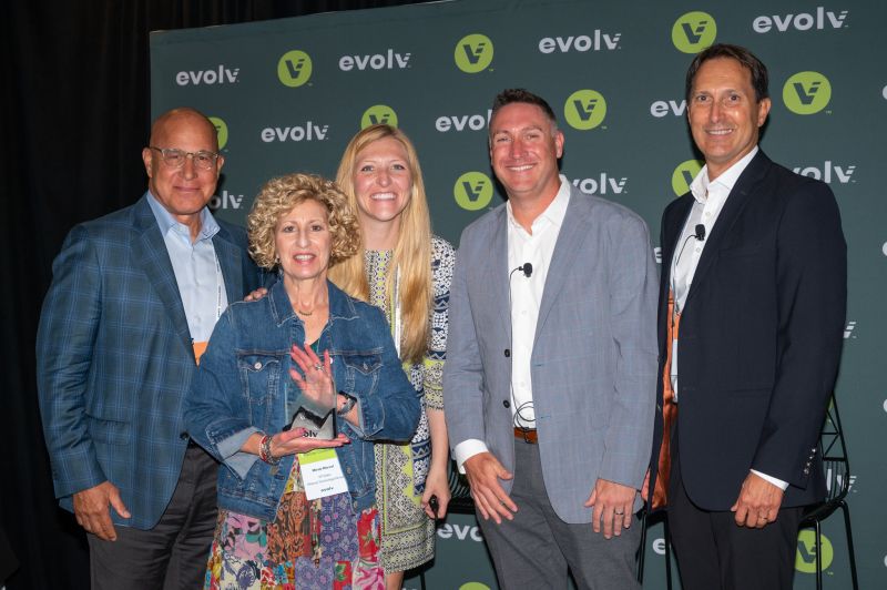 Five people at Evolv Technology's inaugural partner conference, including Dana Loof standing front center