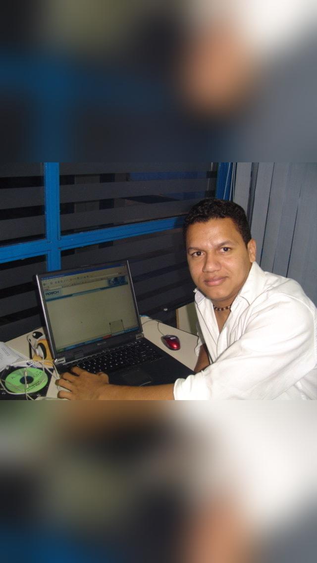 Daniel Alcanja seated at a desk with a laptop, in a photograph shared on Microapp’s founder page