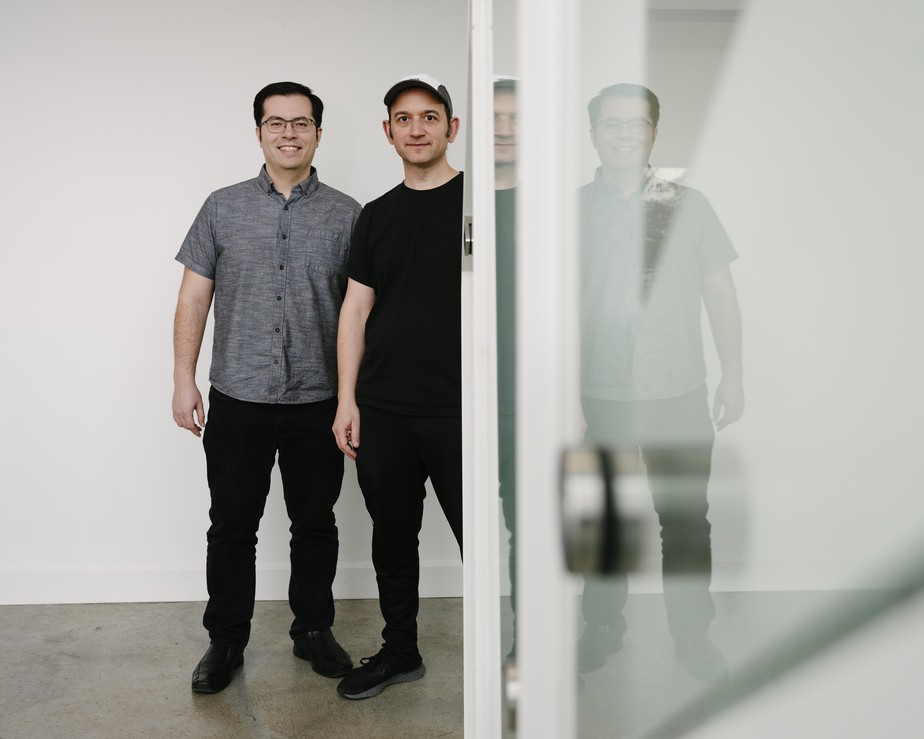 Daniel De Freitas, left, and Character.AI co-founder Noam Shazeer standing together in an office