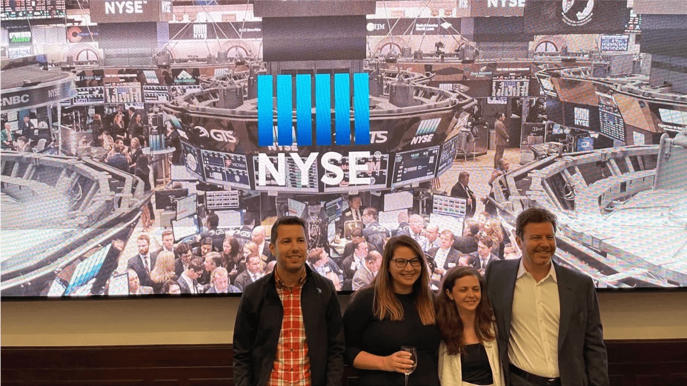 Daniel Dines and colleagues celebrate UiPath’s April 2021 IPO in front of a New York Stock Exchange display