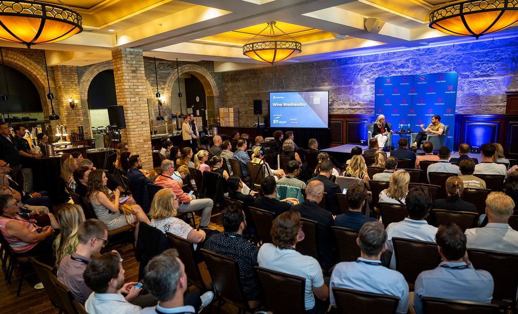 An audience watches Daniel Eberhard, seated at right on stage, at InterGen’s Wine Wednesday in Calgary.