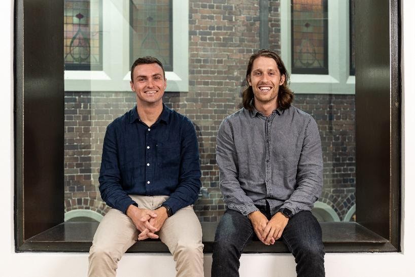 Russell Martin, left, and Daniel Kniaz seated beside an office window