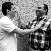 Fabio and Daniel Knijnik smiling together in a black-and-white archival photograph