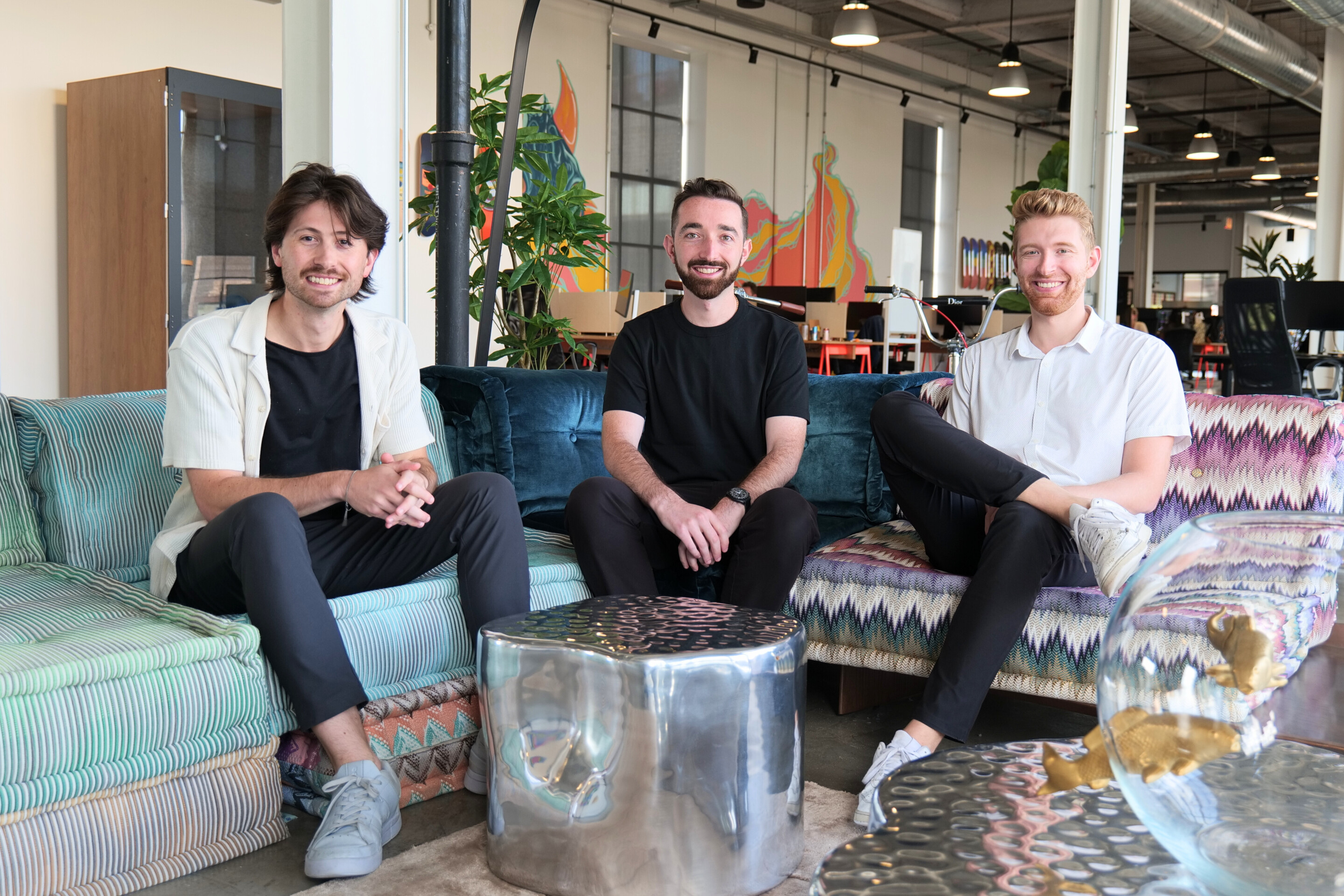 Coinflow co-founders Jake Montgomery, Daniel Lev and Benjamin Meeder seated in their Chicago office