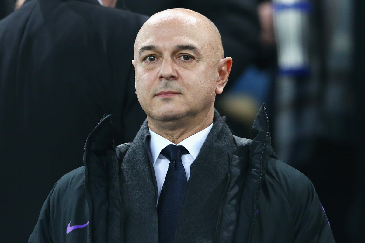 Daniel Levy watching from the touchline in a dark Tottenham coat