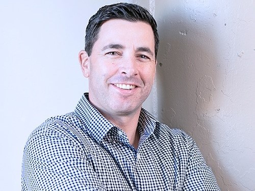 Dan Manchon in a checked shirt, photographed during his time at Provation