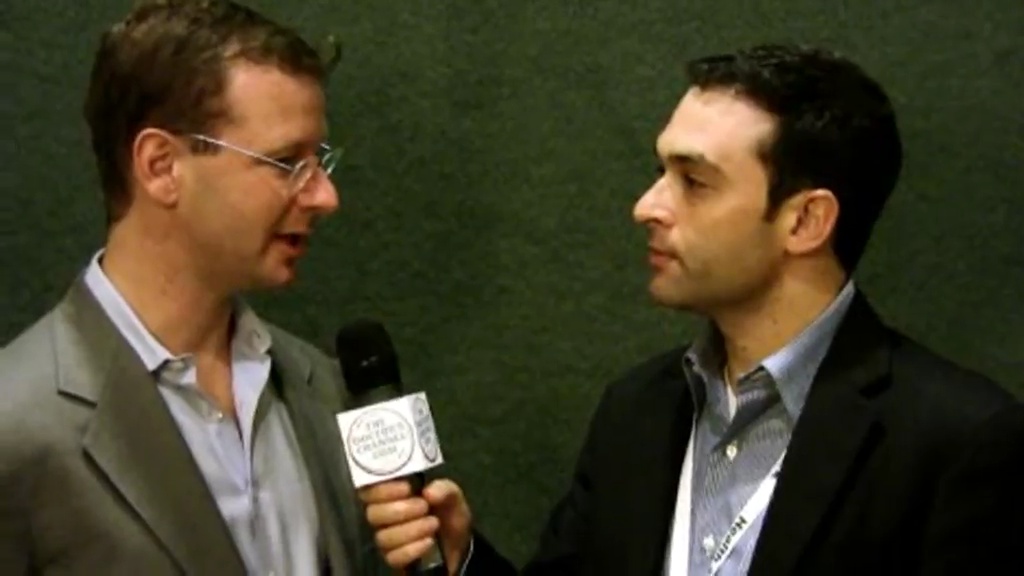 Daniel Palestrant, left, speaking with an interviewer at a conference