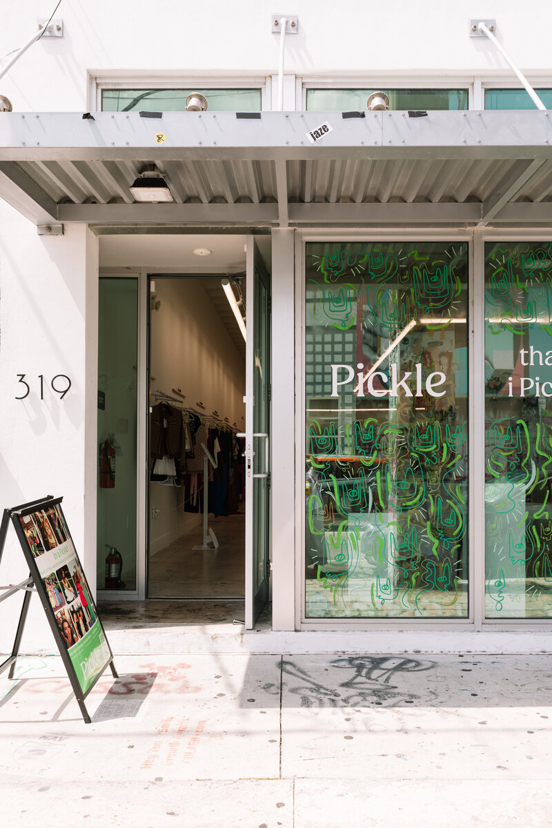 The storefront of Pickle's Miami pop-up, with green line art covering the windows