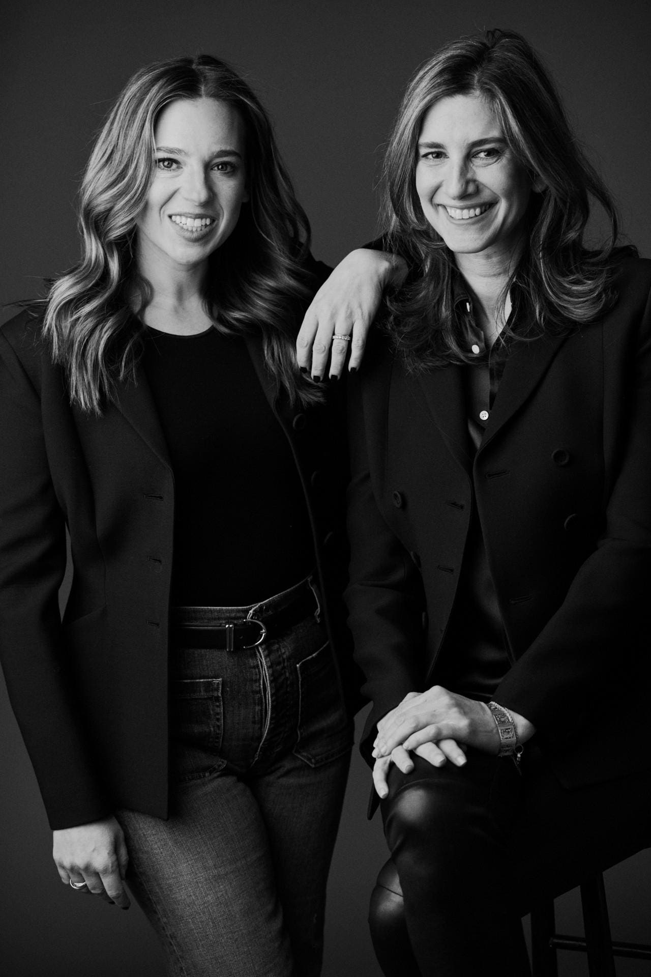 Danielle Weisberg and Carly Zakin in a black-and-white studio portrait