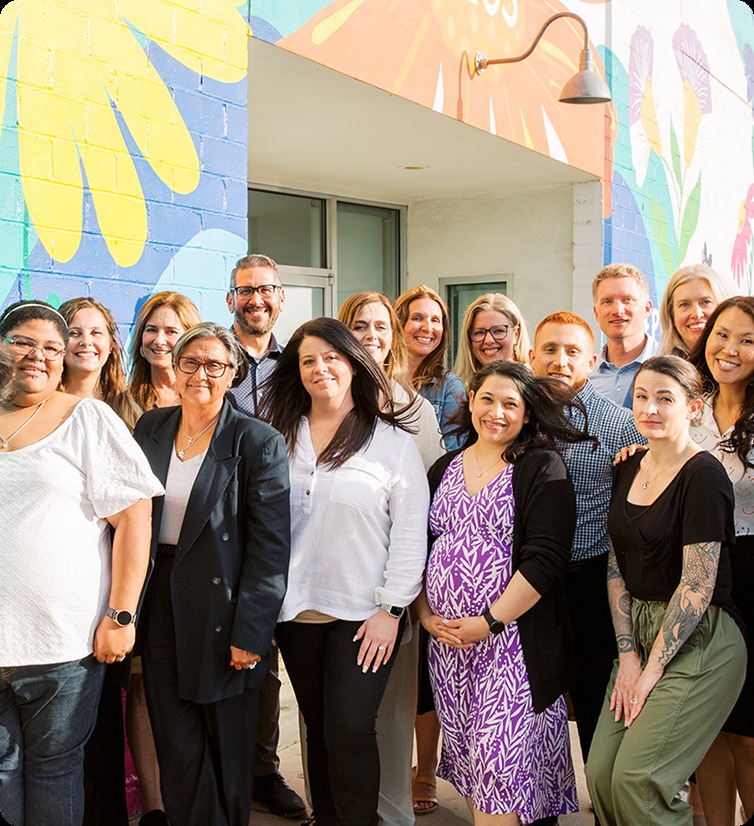 Members of The Helper Bees team gathered outside an Austin office