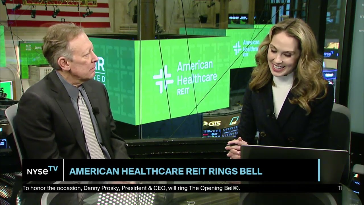 Danny Prosky seated on the left during an NYSE TV interview, with American Healthcare REIT screens behind him.