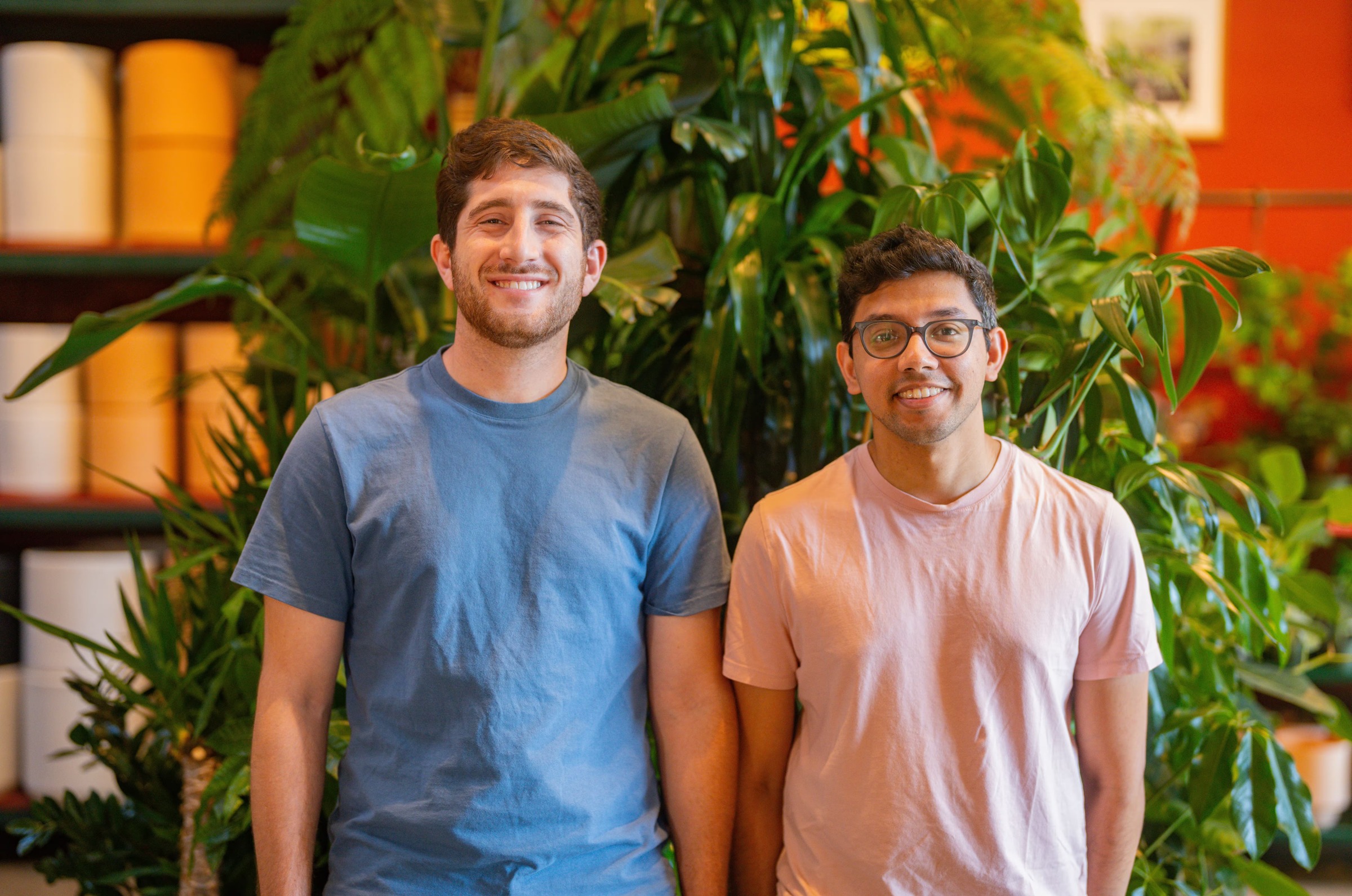 Danny Sheridan, left, and Fern co-founder Deep Singhvi standing together among green plants