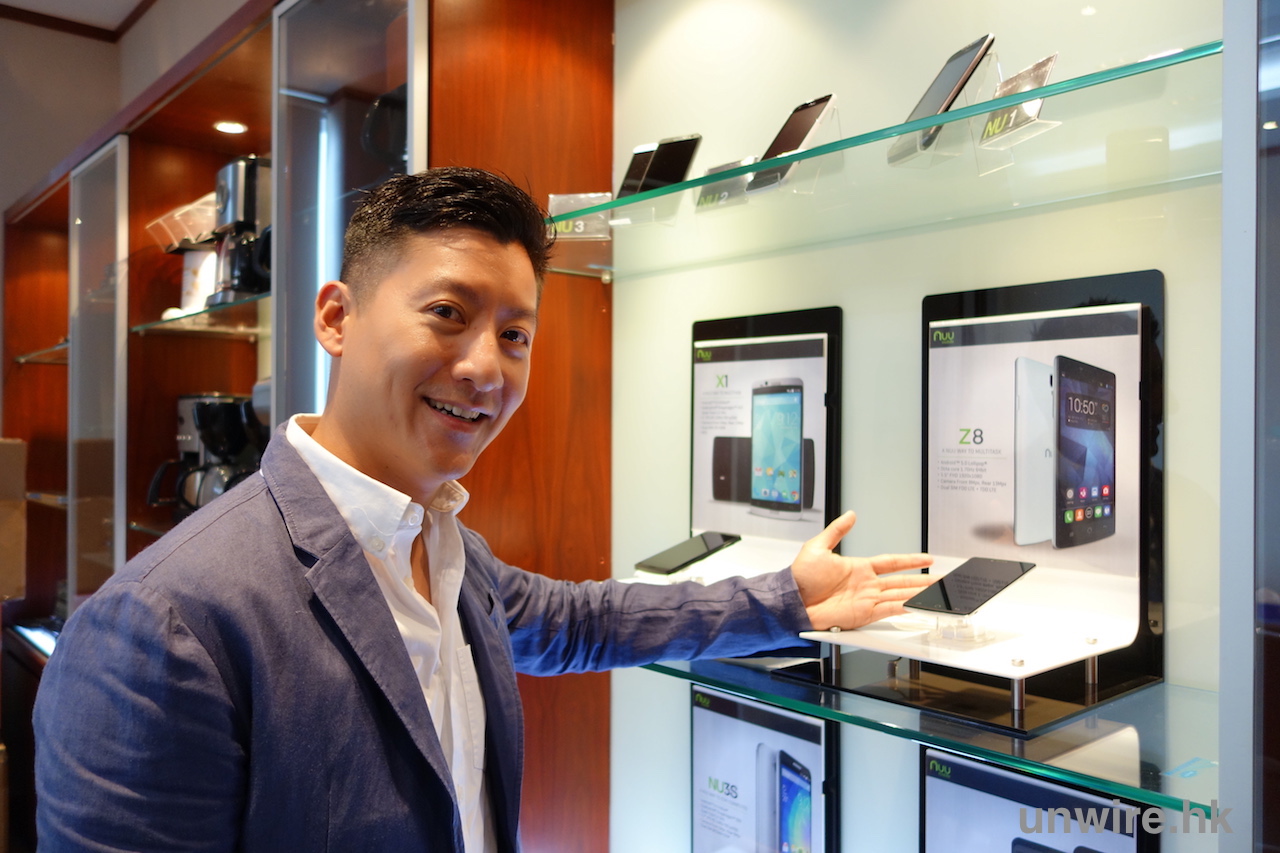 Danny Sit presenting NUU phones in a glass display cabinet in 2015