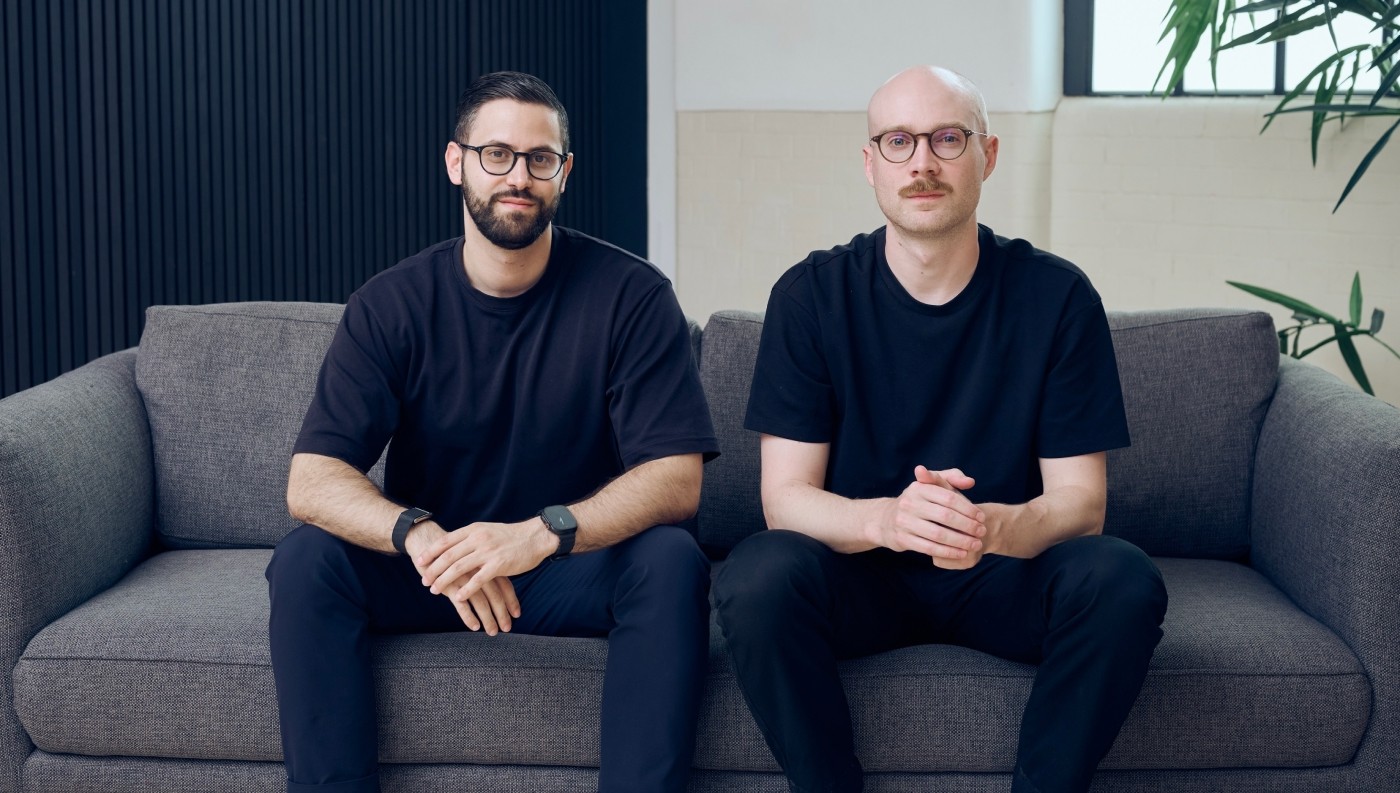 Danyal Özdüzenciler on the left, seated beside Capsa AI co-founder Callum Downie