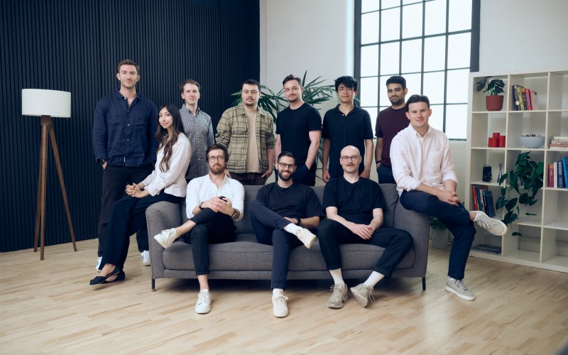The Capsa AI team gathered around a sofa in an office