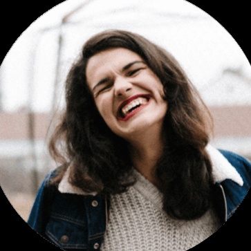 Daria González smiling outdoors, in her Forbes Agency Council photograph