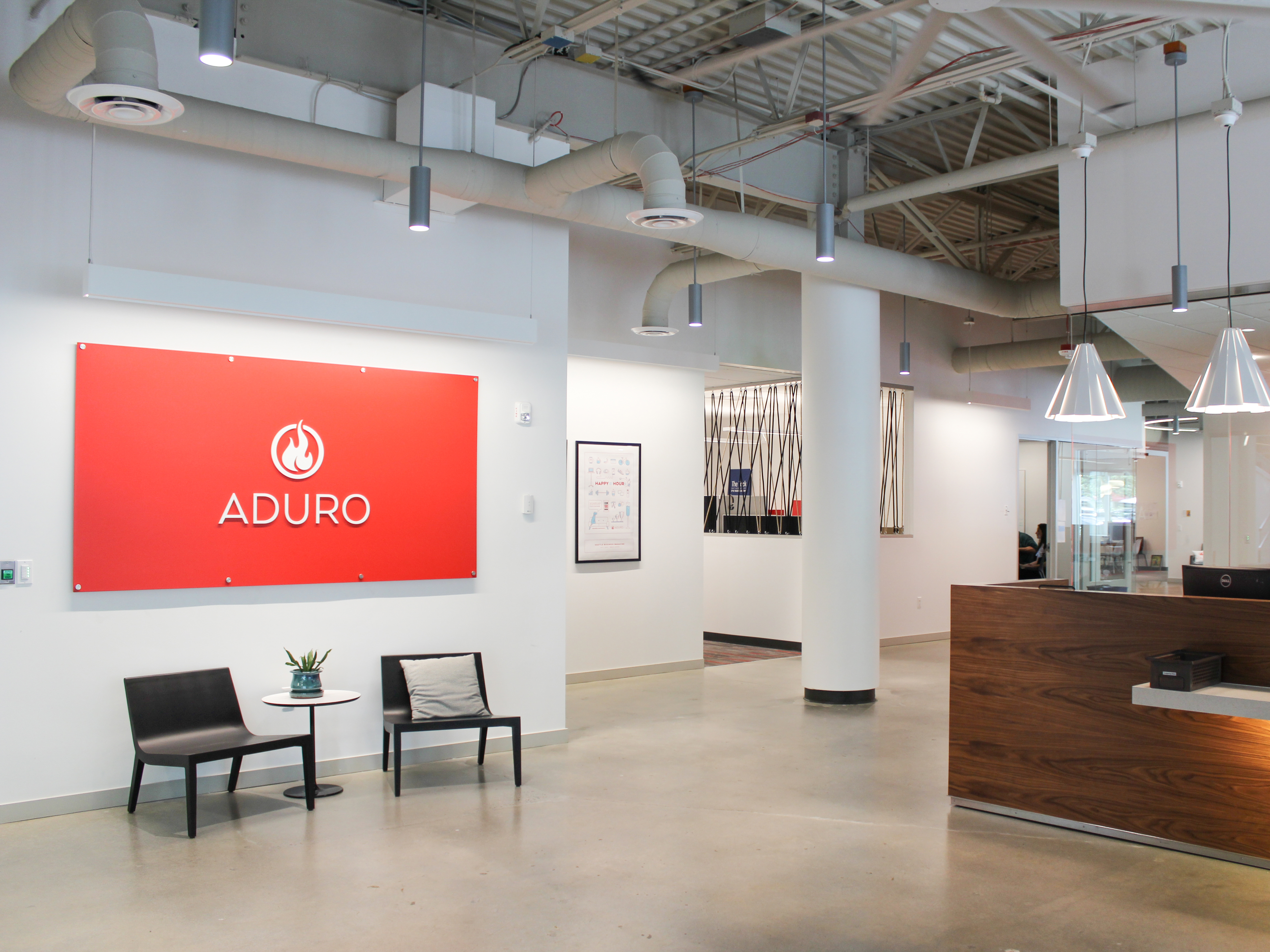 Aduro’s Redmond office reception with its former circular flame logo on an orange wall