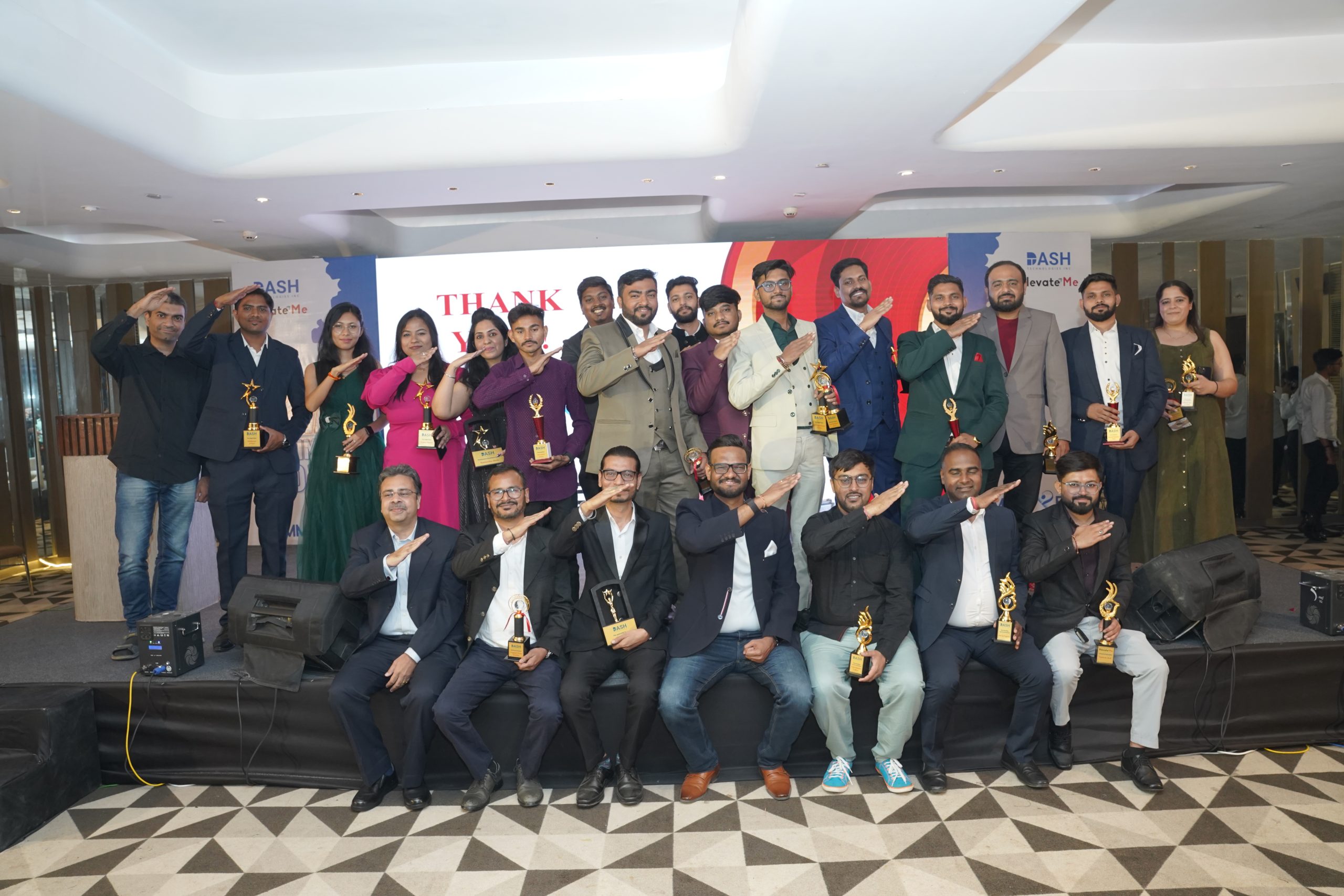 Dash team members gathered on a stage with trophies at a company event