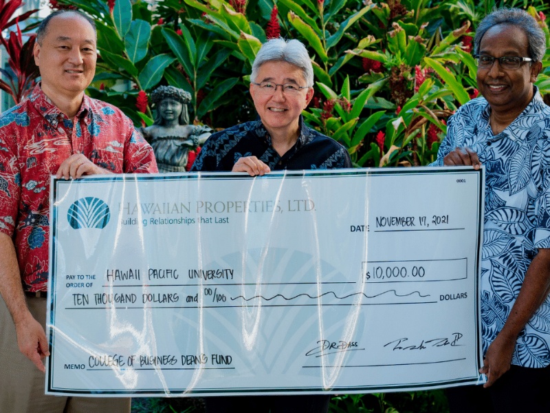 Frank Tokioka, HPU president John Gotanda and Dass Ramadass, at right, presenting a Hawaiian Properties donation in 2021