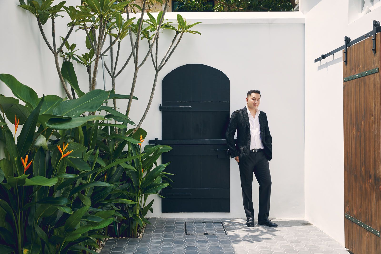Dato' Eric Cheng standing in the courtyard of a carefully restored Singapore home