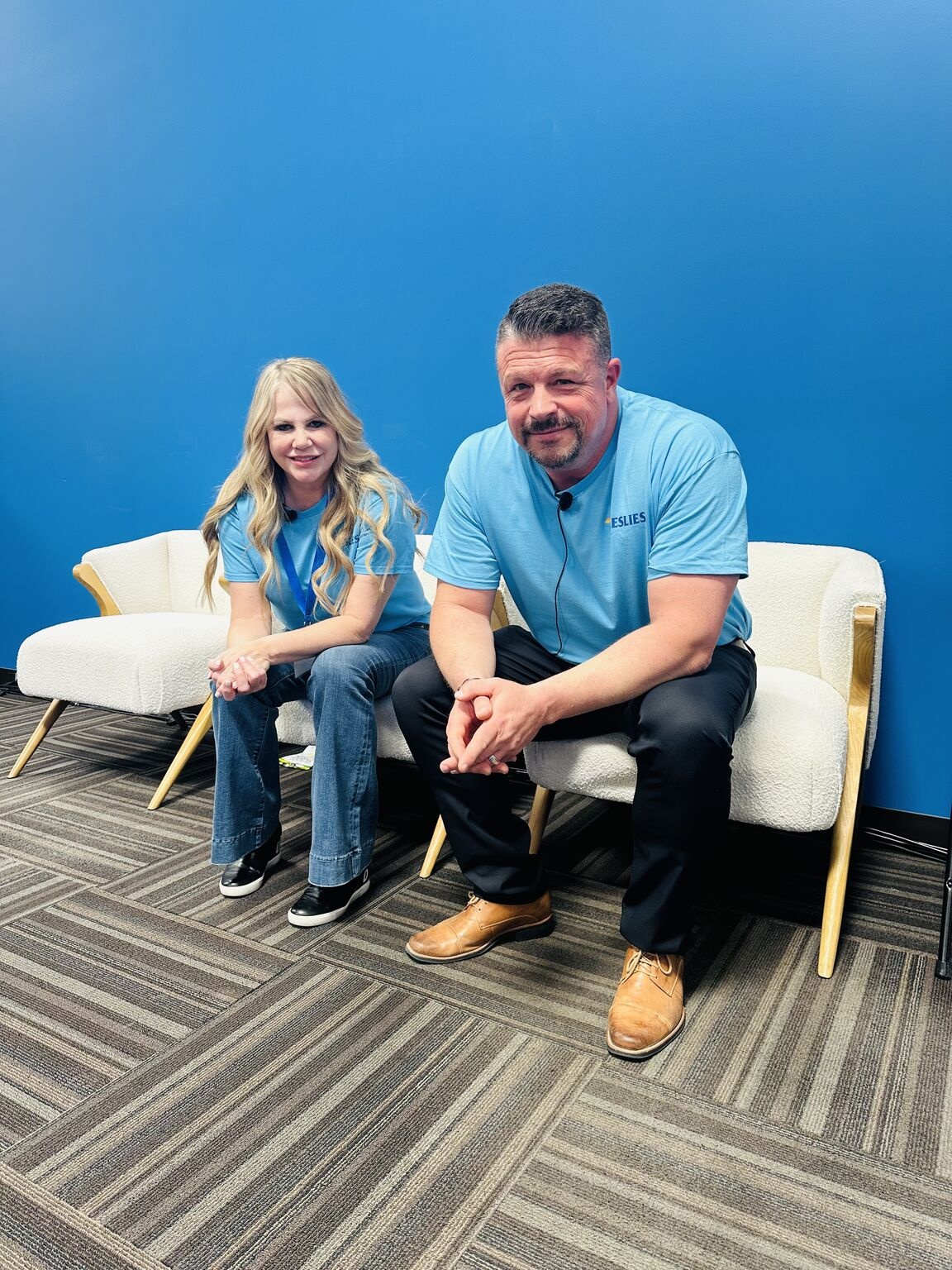 Naomi Cramer and Dave Caspers seated in blue Leslie’s shirts at a company gathering