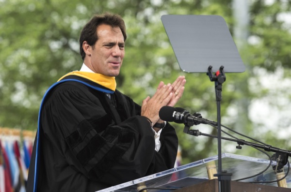 Dave DeWalt in academic robes speaking at a lectern at Delaware’s 2015 commencement