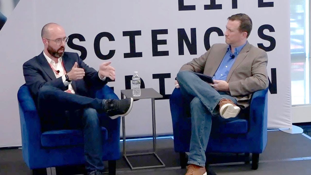 Dave Johnson, seated at left, gesturing during a fireside conversation at RevX Philadelphia.