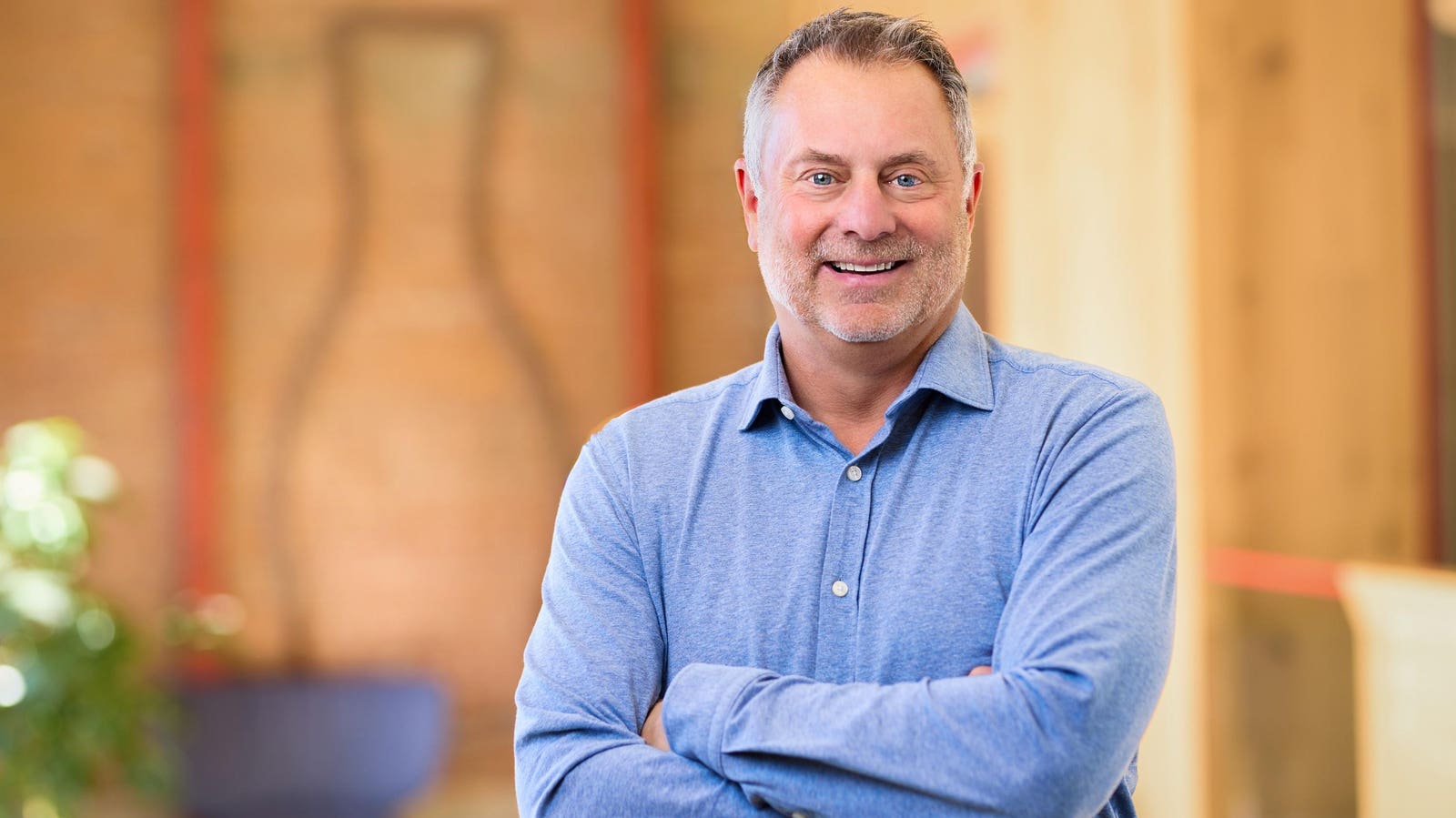 Dave Ritterbush seated in a blue shirt, smiling at the camera