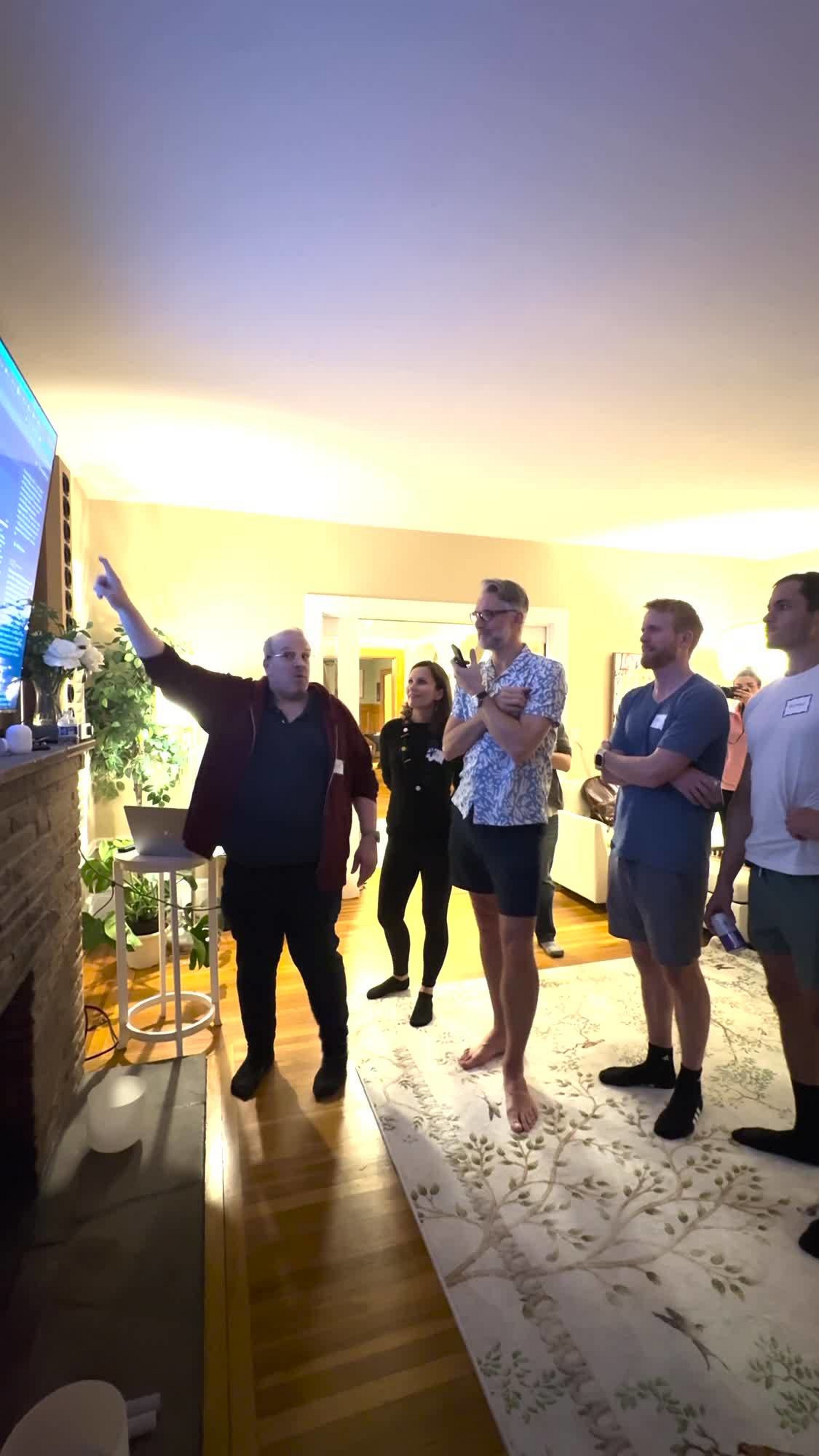 Dave Sifry points toward a presentation screen while attendees watch at Vibe House SF.