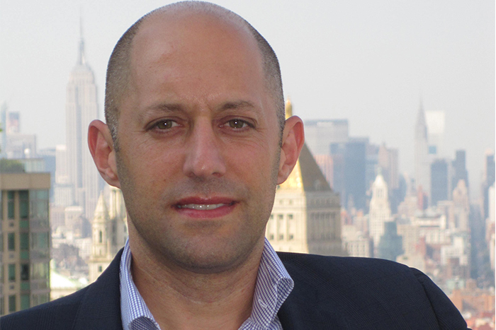 Dave Wechsler photographed with the Manhattan skyline behind him