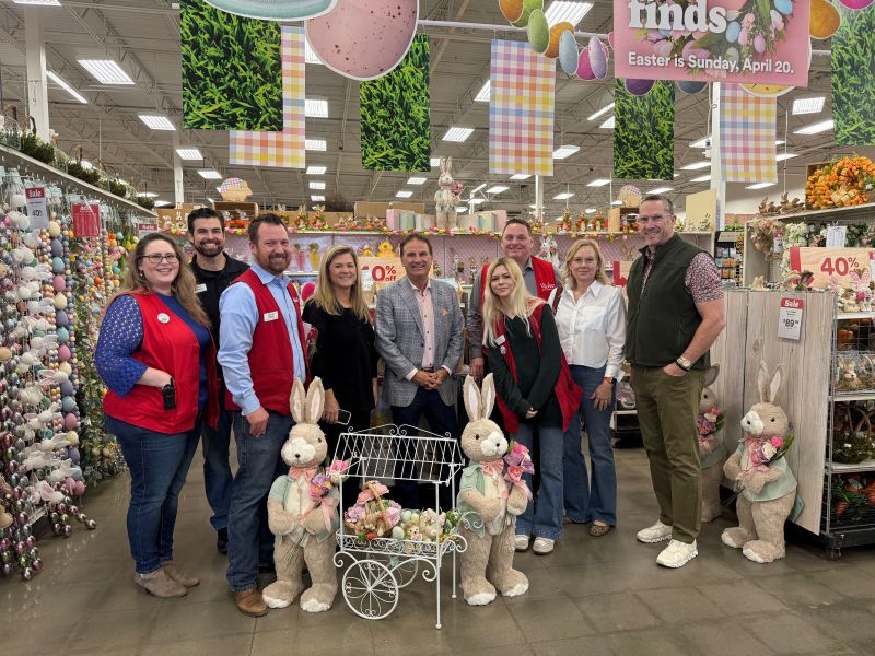 David Boone with Michaels store employees among spring decorations on his first day as CEO