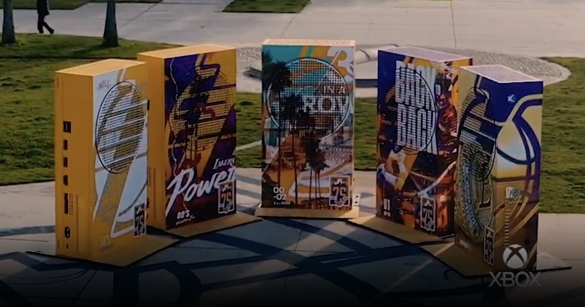 Five oversized Xbox consoles with Lakers graphics displayed outdoors