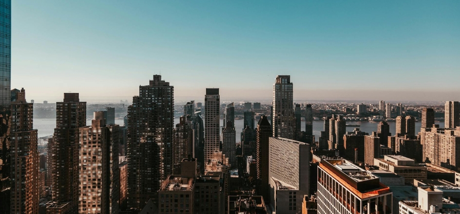 New York towers and river under a clear sky
